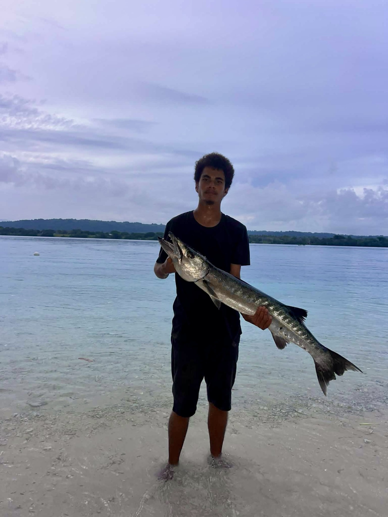 Angler holding a giant trevally caught on an Aore Sport Fishing charter, Vanuatu 5