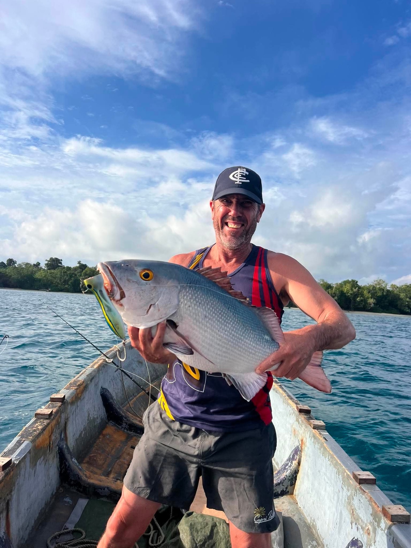 Angler holding a giant trevally caught on an Aore Sport Fishing charter, Vanuatu 3