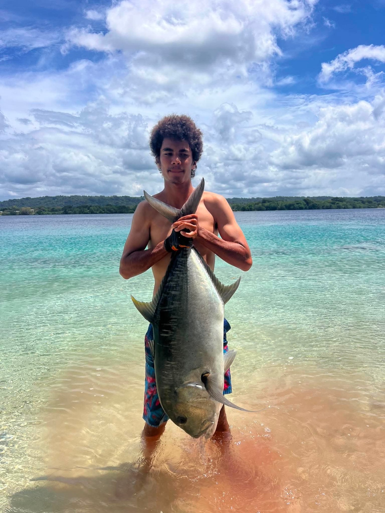 Angler holding a giant trevally caught on an Aore Sport Fishing charter, Vanuatu 2