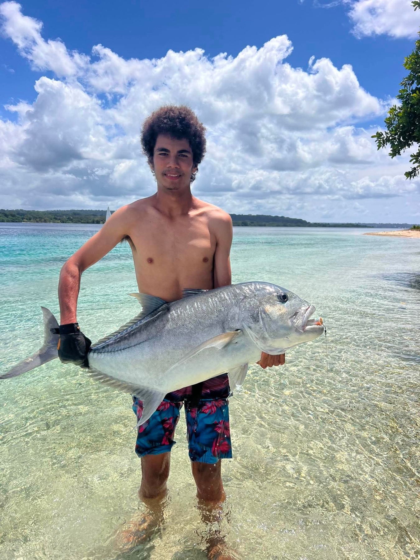 Angler holding a giant trevally caught on an Aore Sport Fishing charter, Vanuatu