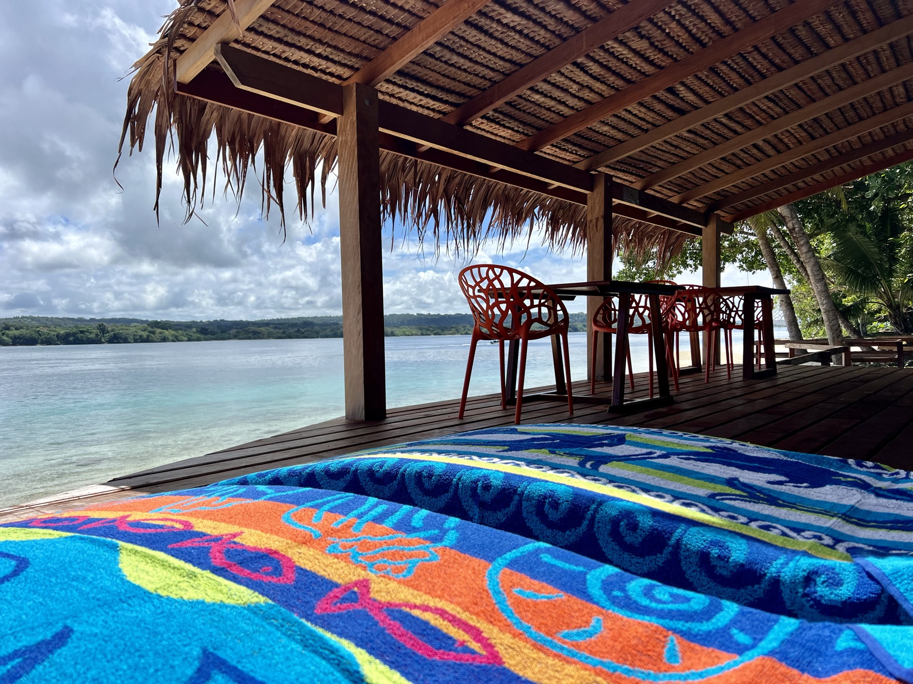 Lapita Beach Villa beachfront deck with day beds and dining under thatch, Aore Island 2